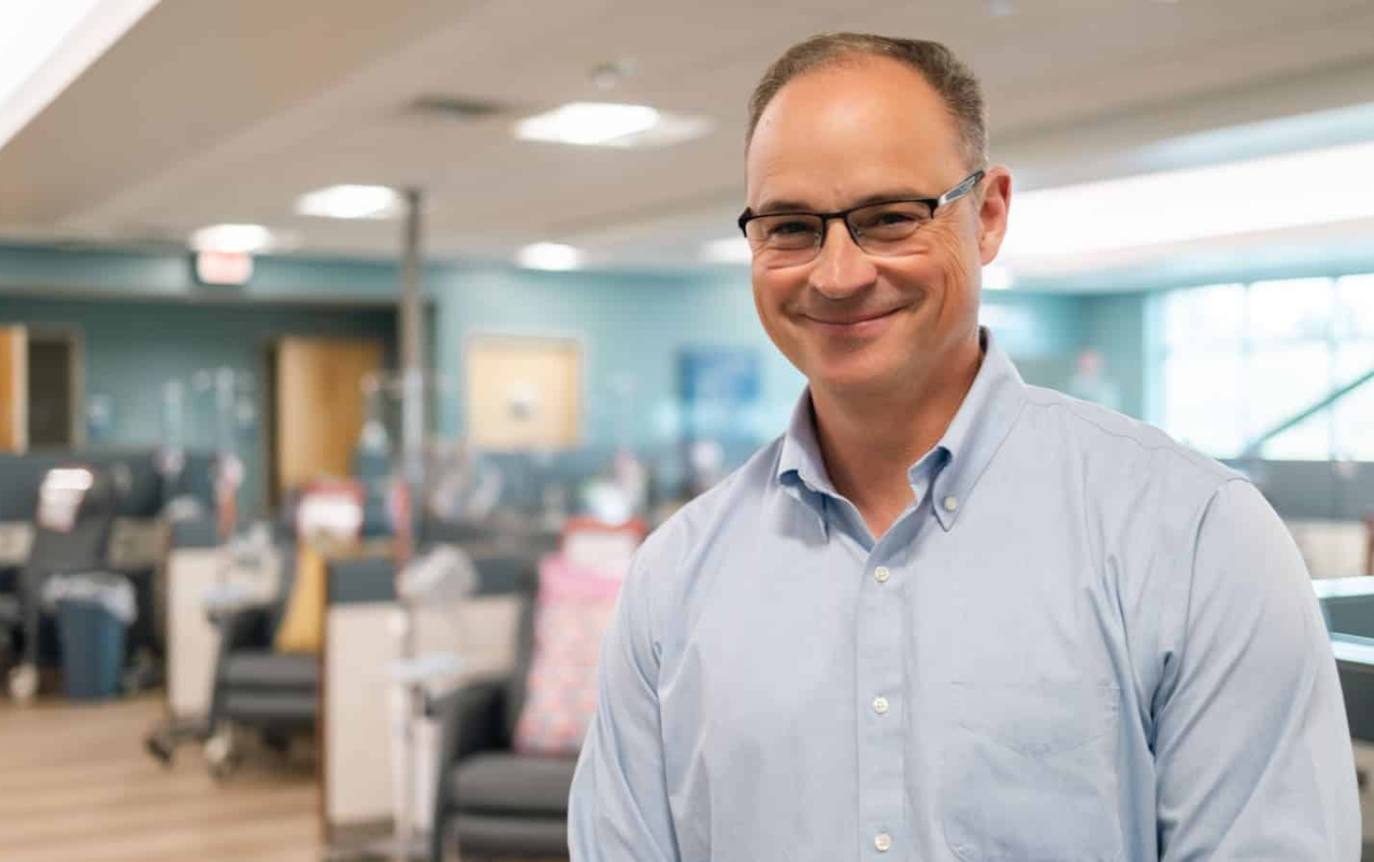 Oncologist welcoming patients to treatment room